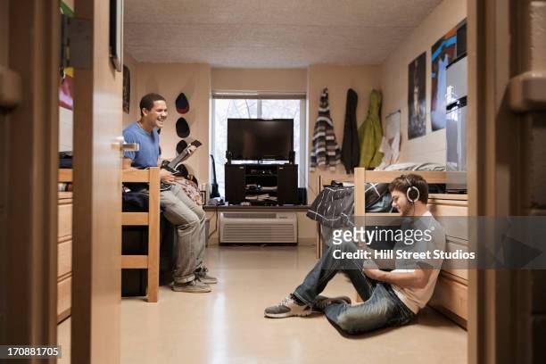 students relaxing in dorm room - college dorm stock pictures, royalty-free photos & images