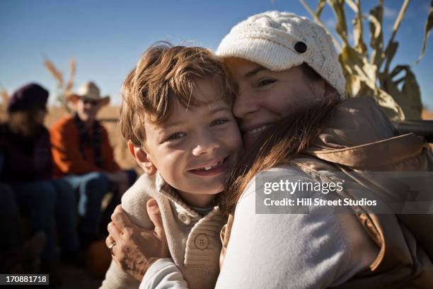 caucasian mother and son smiling together - passeggiata su un carro di fieno foto e immagini stock