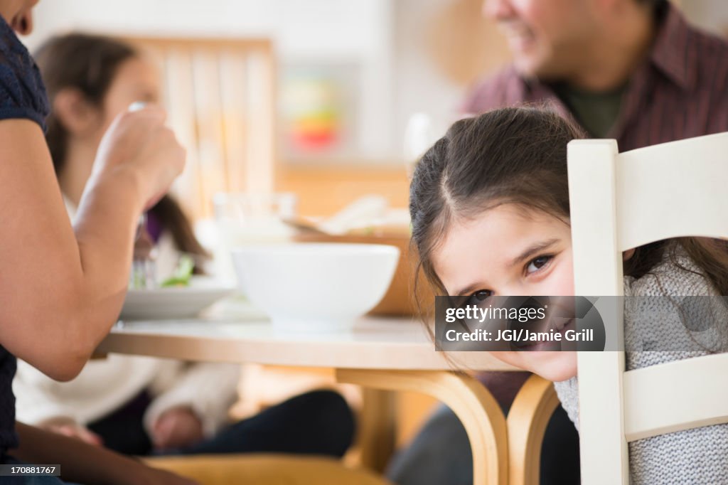 Smiling girl sitting at table