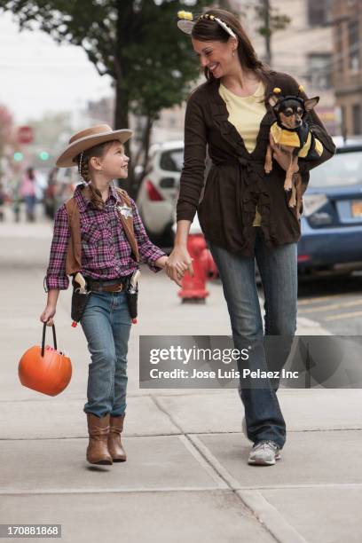 caucasian mother and daughter walking in halloween costumes - bee costume adult fotografías e imágenes de stock