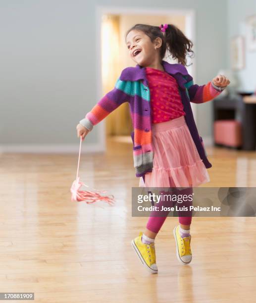 hispanic girl playing with streamers - young people dancing stock pictures, royalty-free photos & images