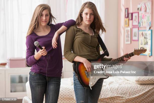 caucasian girls playing music in bedroom - girl band stock pictures, royalty-free photos & images