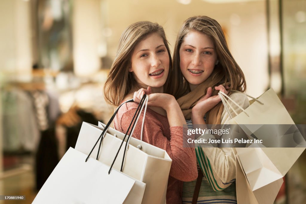 Caucasian girls carrying shopping bags