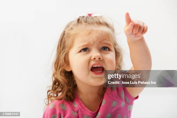 caucasian toddler pointing - exigir fotografías e imágenes de stock