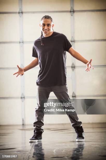 hispanic man standing in studio - hip hop culture stock pictures, royalty-free photos & images