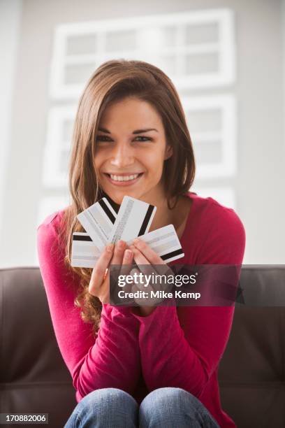 caucasian woman holding credit cards - one in four people stock pictures, royalty-free photos & images