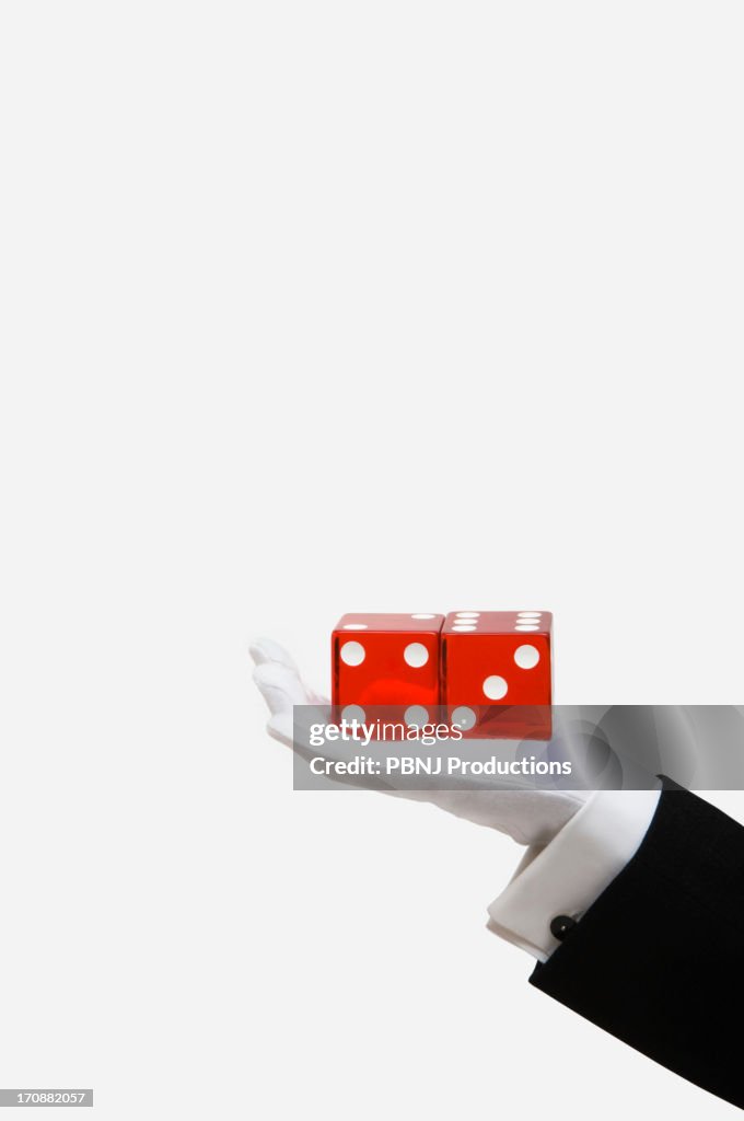 Caucasian magician holding red dice