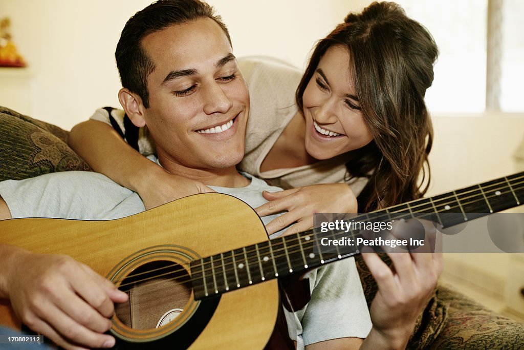 Man playing guitar for girlfriend