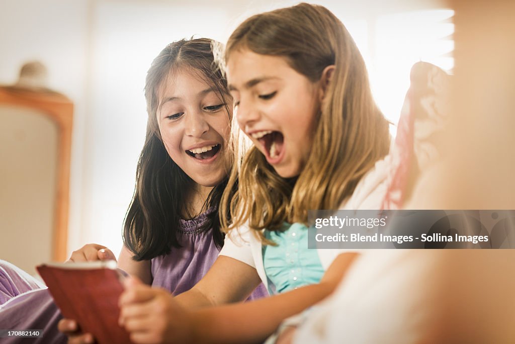 Girls using digital tablet together