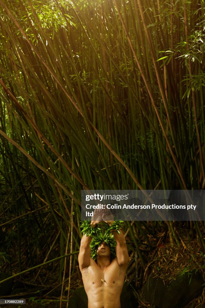 Hawaiian man wearing traditional outfit in jungle