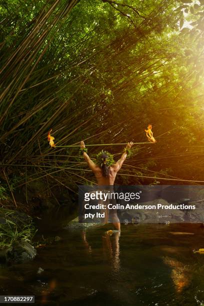 hawaiian man in traditional outfit holding torch - men in loincloths stock pictures, royalty-free photos & images
