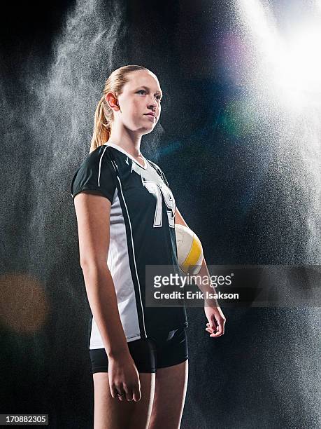 caucasian volleyball player standing under lights - volleyball player photos et images de collection