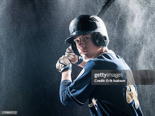 caucasian baseball player standing in rain - baseball helmet fotografías e imágenes de stock