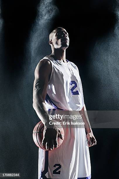 african american basketball player standing under lights - uniforme di basket foto e immagini stock