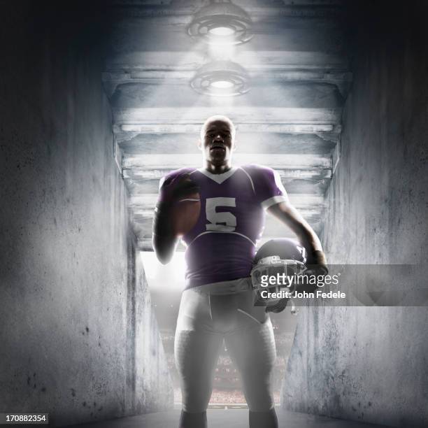 african american football player standing in hallway - football player tunnel stock pictures, royalty-free photos & images