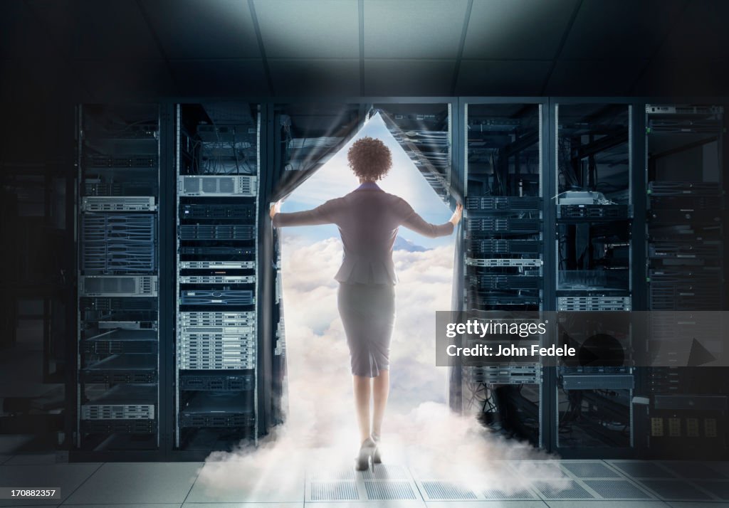 African American businesswoman walking into clouds