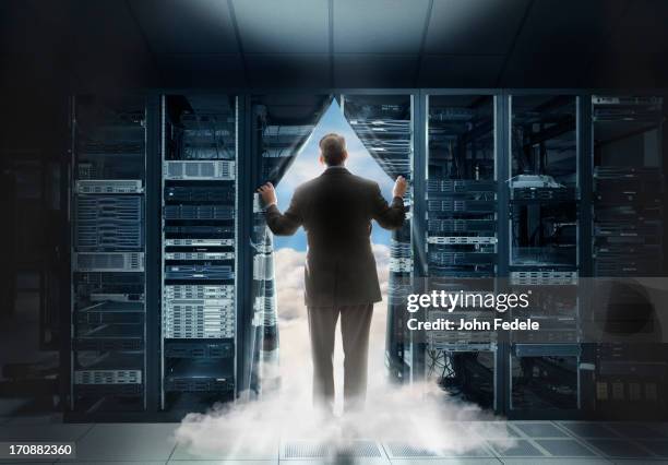 caucasian businessman pulling back curtain to clouds - business cloud stock-fotos und bilder