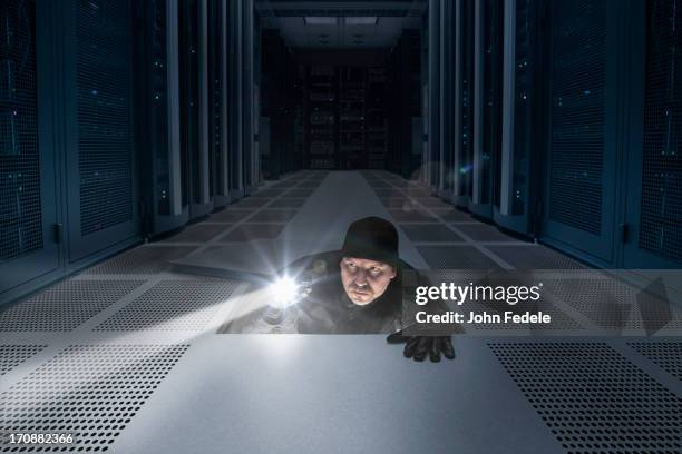 caucasian man shining light in air vent - mainframe stock pictures, royalty-free photos & images