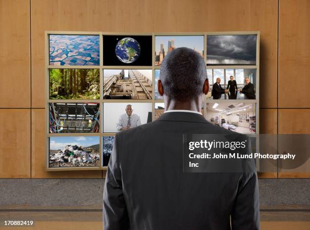 businessman watching collage screen in office - video wall fotografías e imágenes de stock