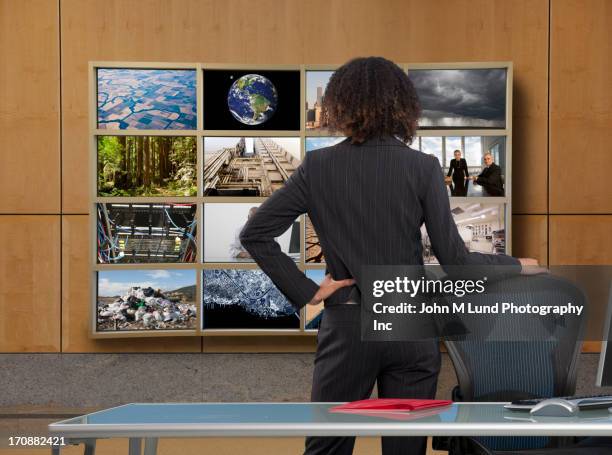 businesswoman watching collage screen in office - global impact stock pictures, royalty-free photos & images
