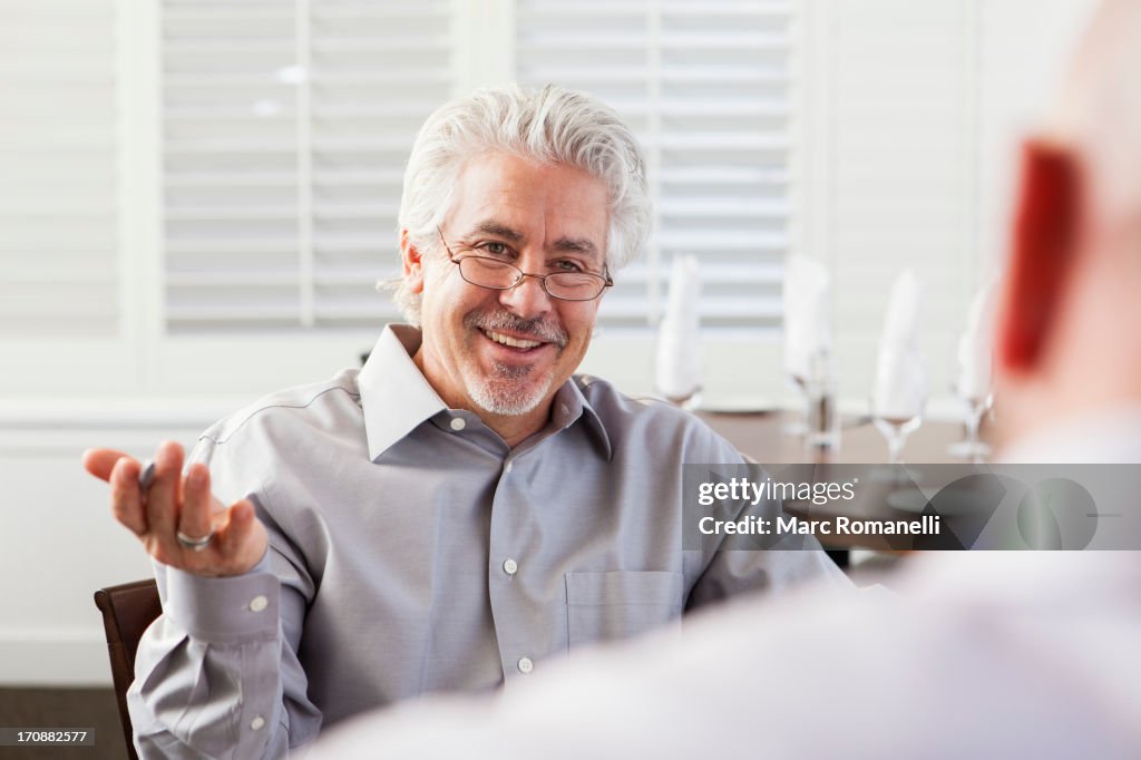 Businessmen talking in cafe