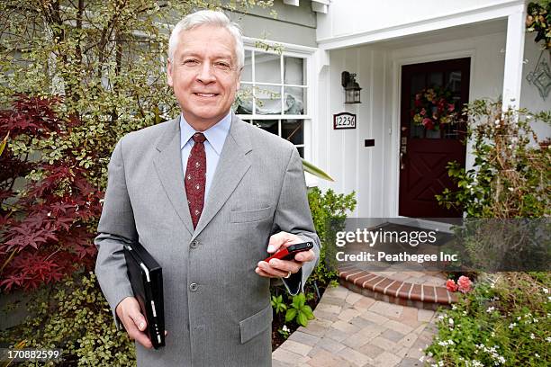businessman using cell phone on front path - one mature man only stock pictures, royalty-free photos & images