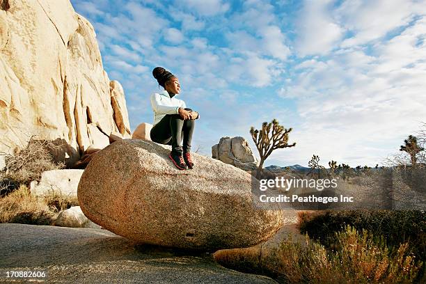 black runner in desert landscape, joshua tree national park, california, united states - african american hiking stock-fotos und bilder