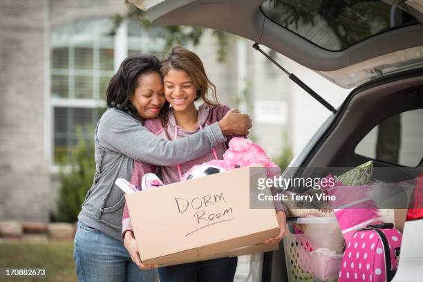 african american mother helping daughter pack for college - teenager alter 個照片及圖片檔