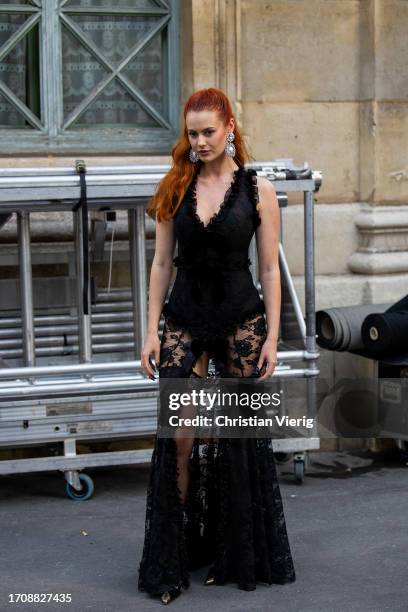Jordan Grant wears black laced dress, strapless tights outside Alessandra Rich during the Womenswear Spring/Summer 2024 as part of Paris Fashion Week...