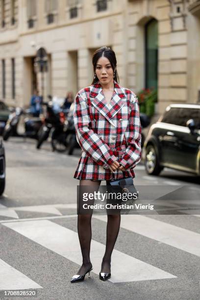 Jenny Tsang wears red white checkered blazer, black bag, tights, heels outside Alessandra Rich during the Womenswear Spring/Summer 2024 as part of...