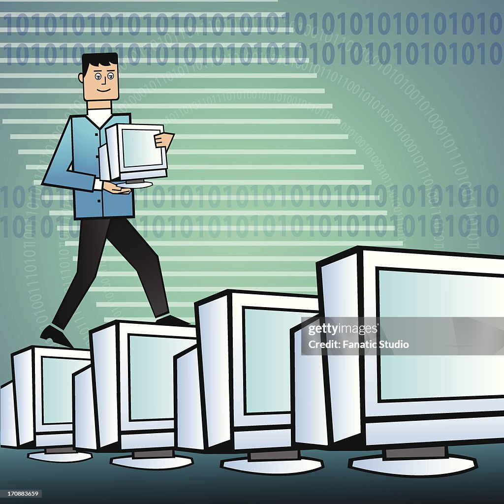 Businessman arranging computers