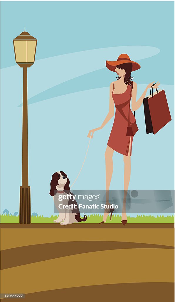 Woman walking in a street with her dog