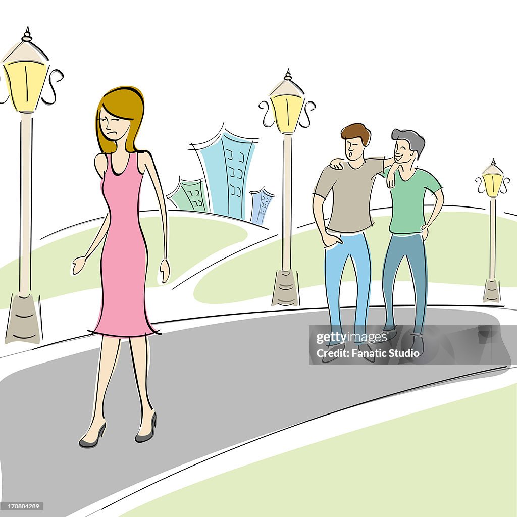 Two men whistling behind a passing by woman in the street