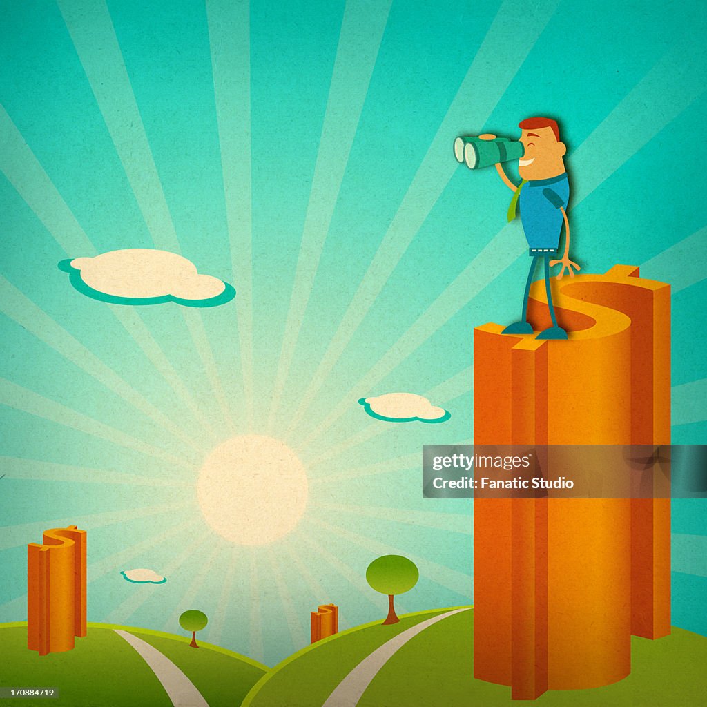 Businessman looking through binoculars