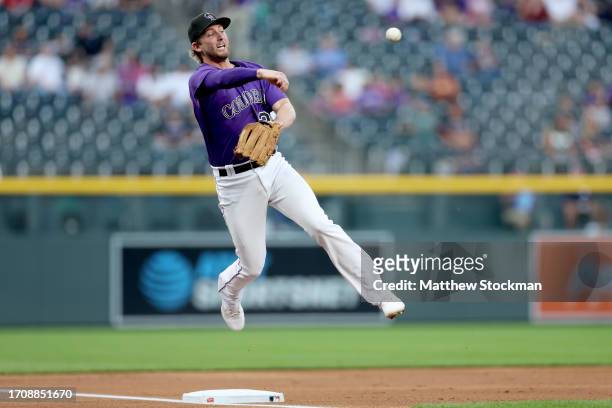 Ryan McMahon of the Colorado Rockies attempts to turn the second half of a double play on a single by Ryan Jeffers of the Minnesota Twins in the...