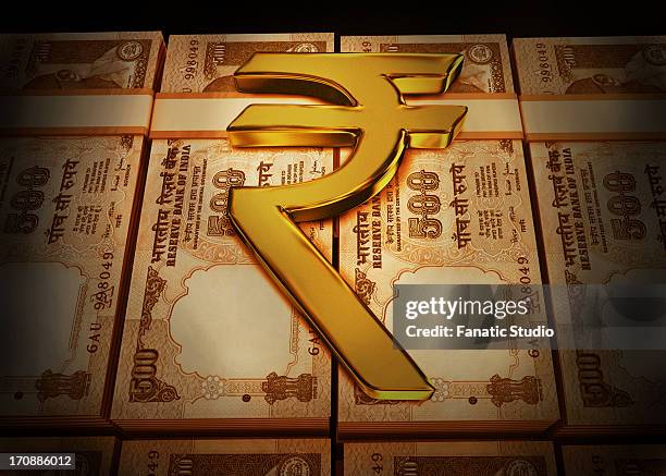 golden rupee symbol on indian currency bundles - indian currency notes stock illustrations