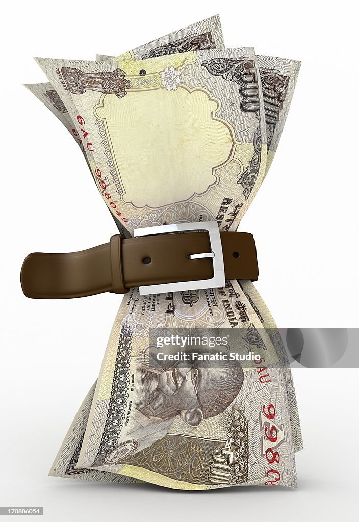 Indian five hundred Rupee note tied up by a belt