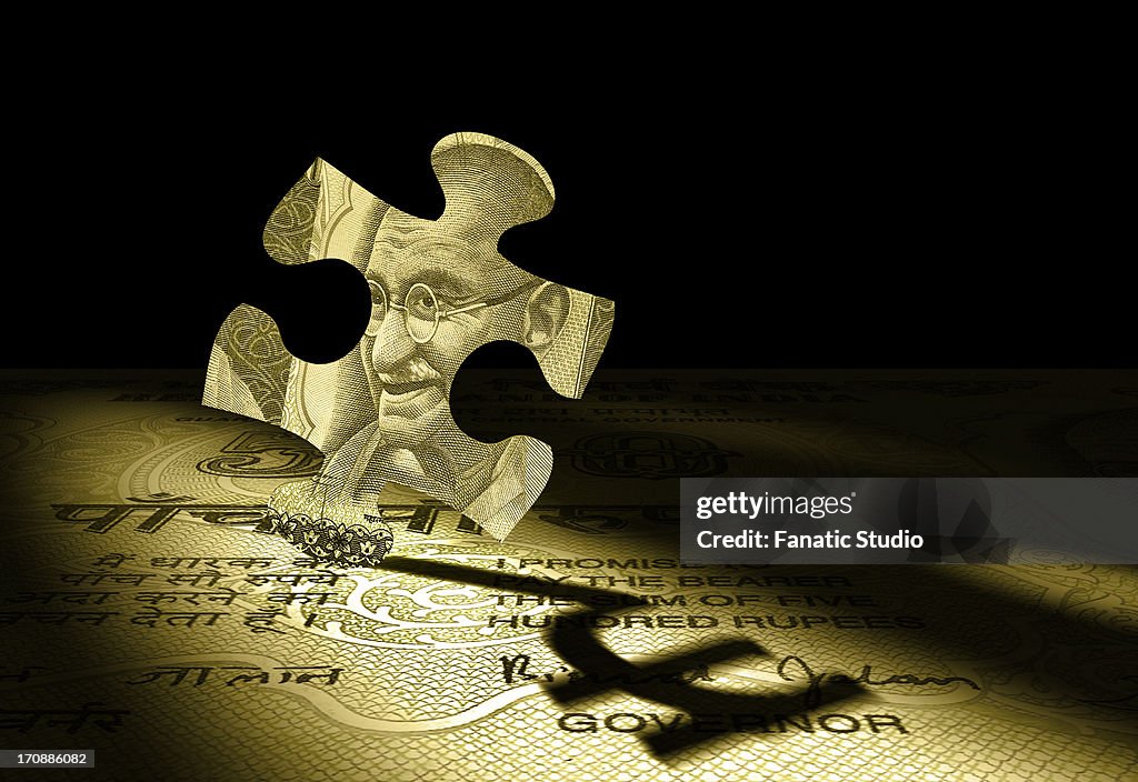 Jigsaw puzzle reflecting Indian currency symbol