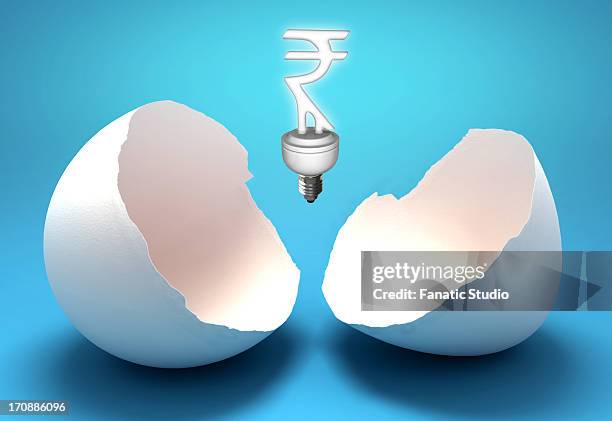 rupee sign shaped light bulb representing concept of power saving - cracking egg stock illustrations