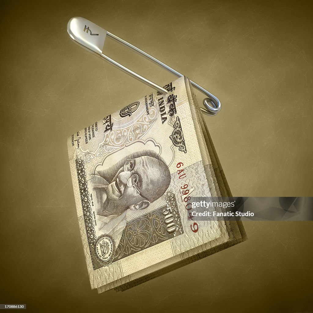 Indian five hundred rupee notes pinned in a safety pin