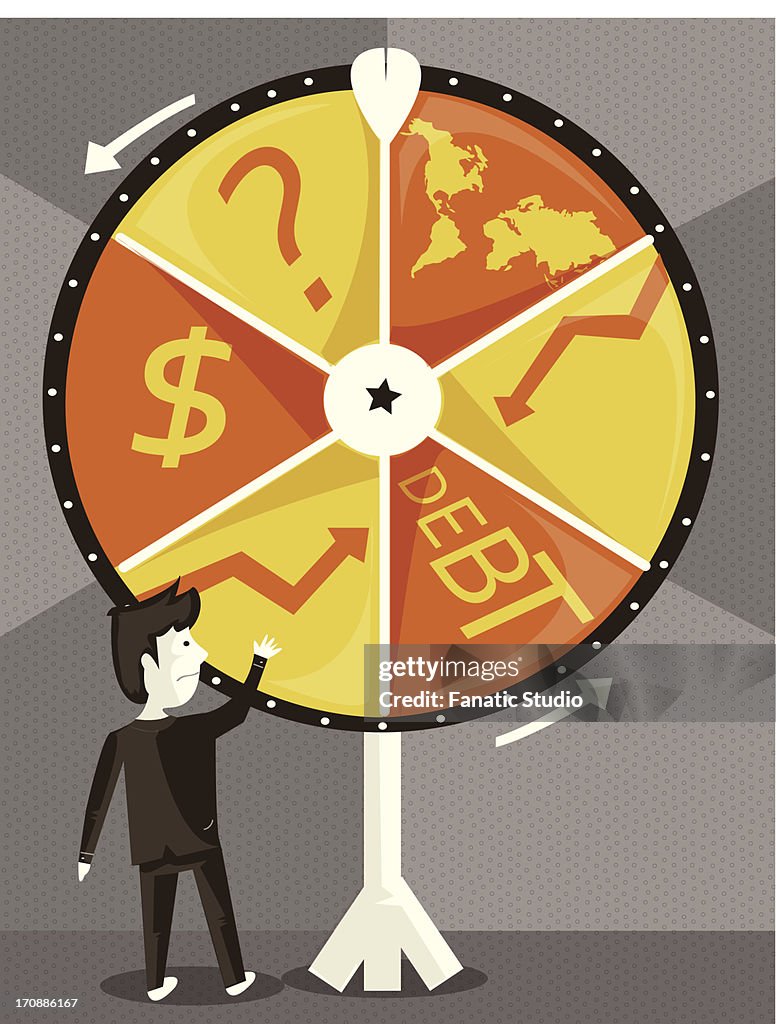 Businessman with spinning wheel of business cycle trying his luck
