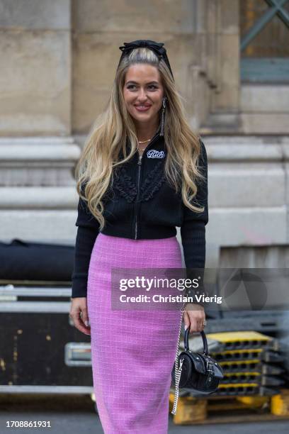 Emili Sindlev wears head band, pink skirt, black zipper jacket, bag outside Alessandra Rich during the Womenswear Spring/Summer 2024 as part of Paris...