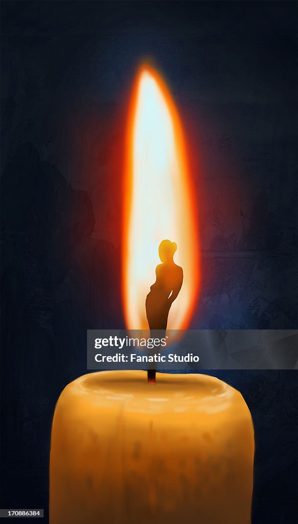 Essence of a woman burning in candle flame over black background