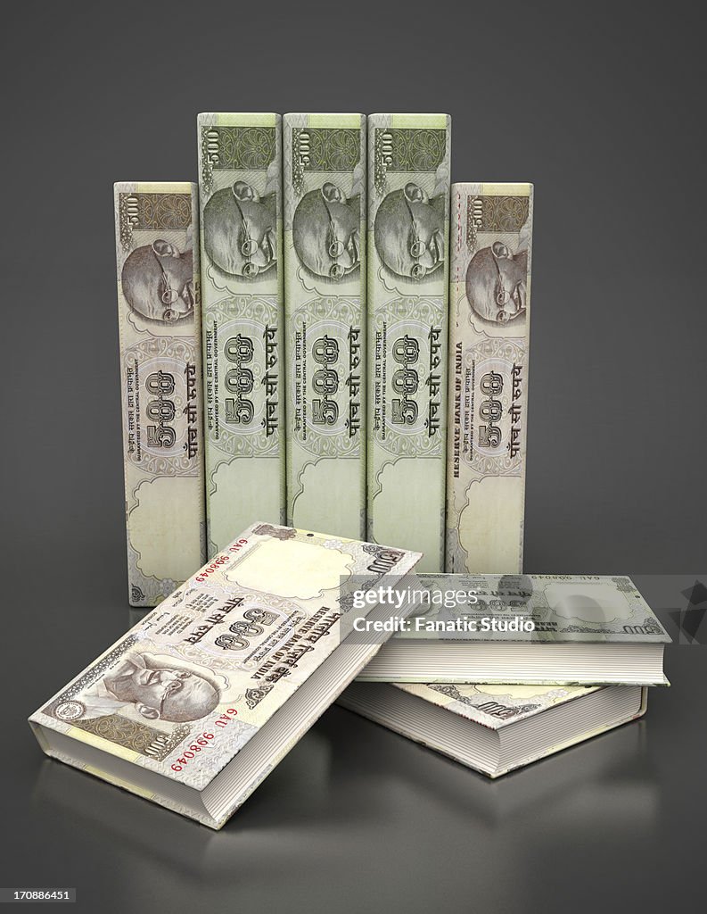 Book covers of Indian currency representing education loan