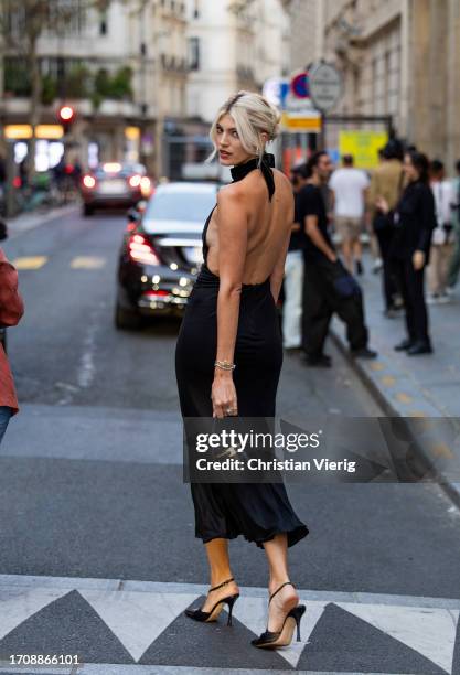 Devon Windsor wears black cut out dress outside Alessandra Rich during the Womenswear Spring/Summer 2024 as part of Paris Fashion Week on September...