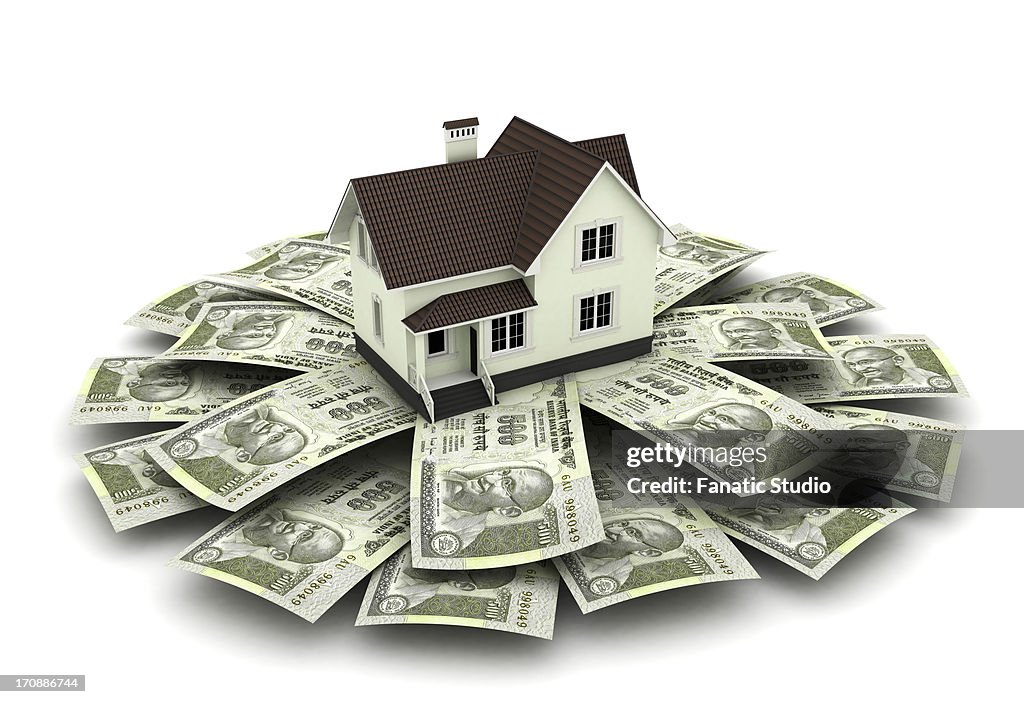 Illustrative image of model home on top of Indian currency over white background