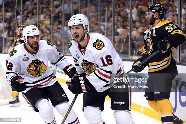 Kaspars Daugavins of the Boston Bruins celebrates with Michal Rozsival after scoring a goal in the second period against the Boston Bruins in Game...