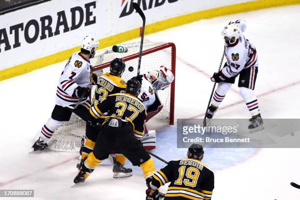 Patrice Bergeron of the Boston Bruins scores a goal in the second period against Corey Crawford of the Chicago Blackhawks in Game Four of the 2013...