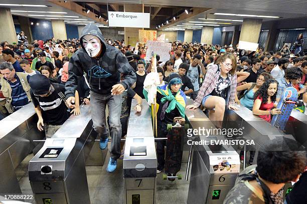 Students invade a subway station during a protest calling for a public transport free pass in the Federal District, on June 19, 2013 in Brasilia....