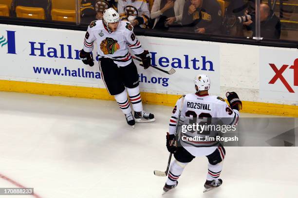 Patrick Kane of the Chicago Blackhawks celebrates with Michal Rozsival after Kane scores a goal in the second period against the Boston Bruins in...